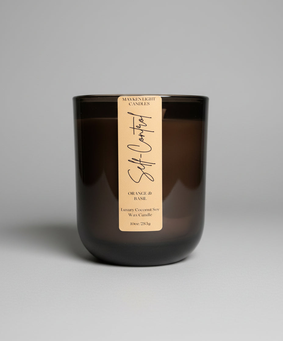 Dark glass candle with a label on a wooden surface