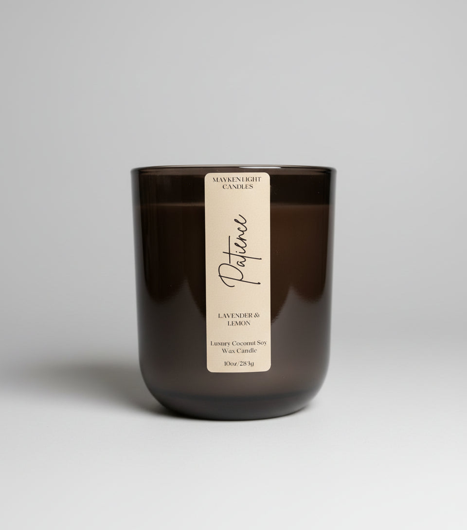 Dark glass candle with a label on a marble surface